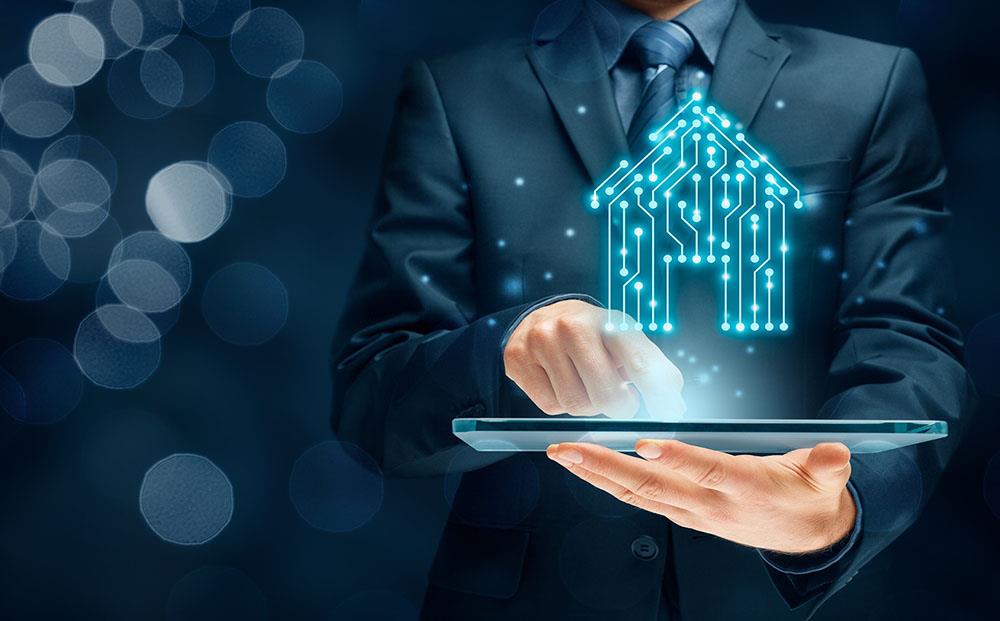 A business man holding a tablet with a digital house